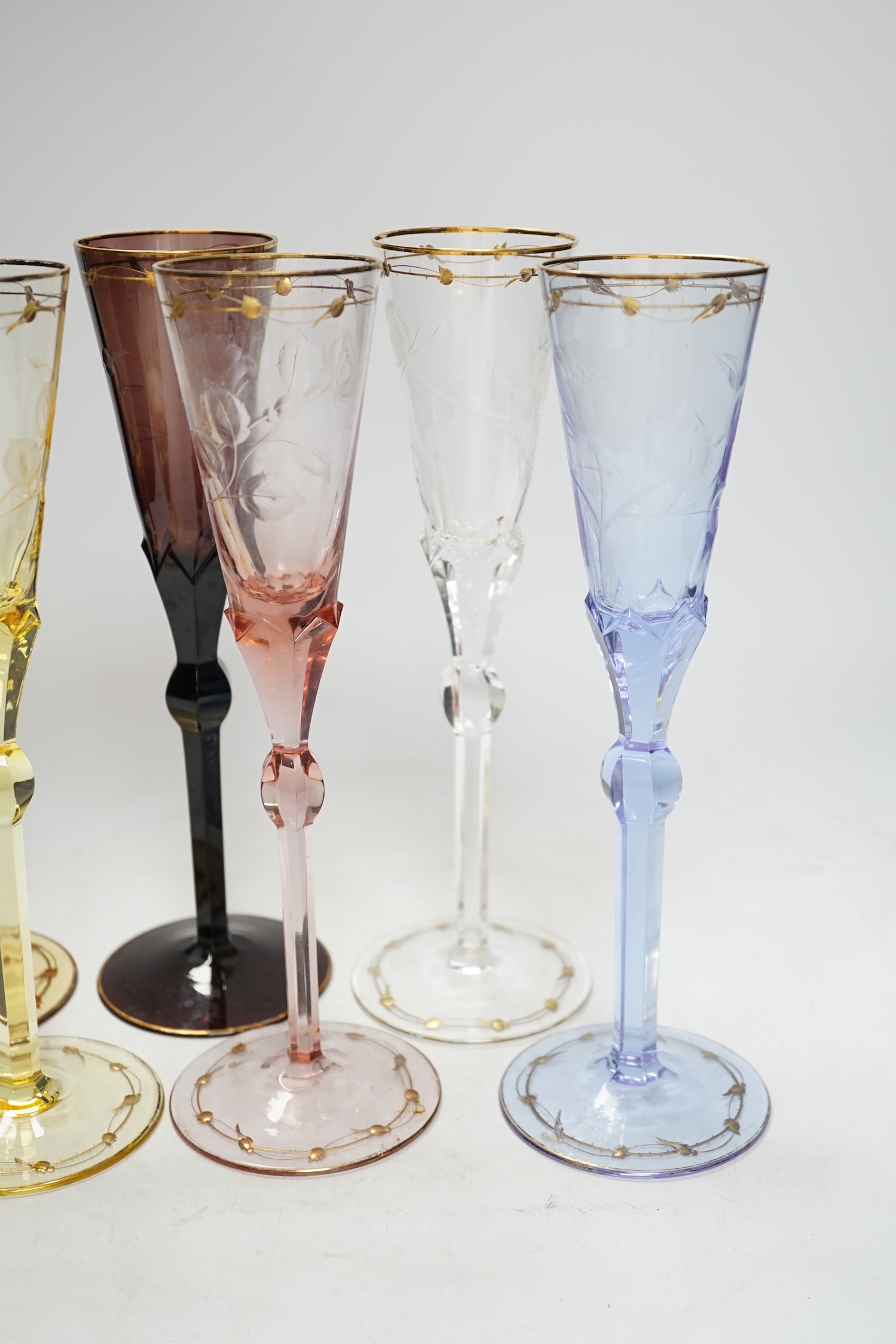 A set of six coloured Moser engraved and gilt enamelled, champagne flutes, 27cm high